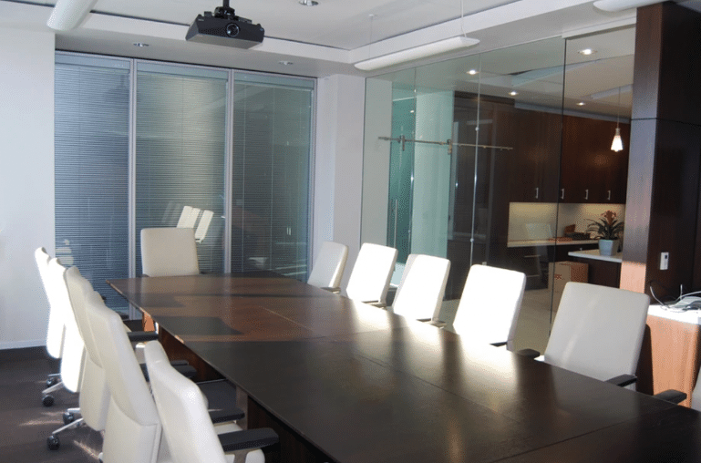 Glass wall partitions in CBRE conference room.